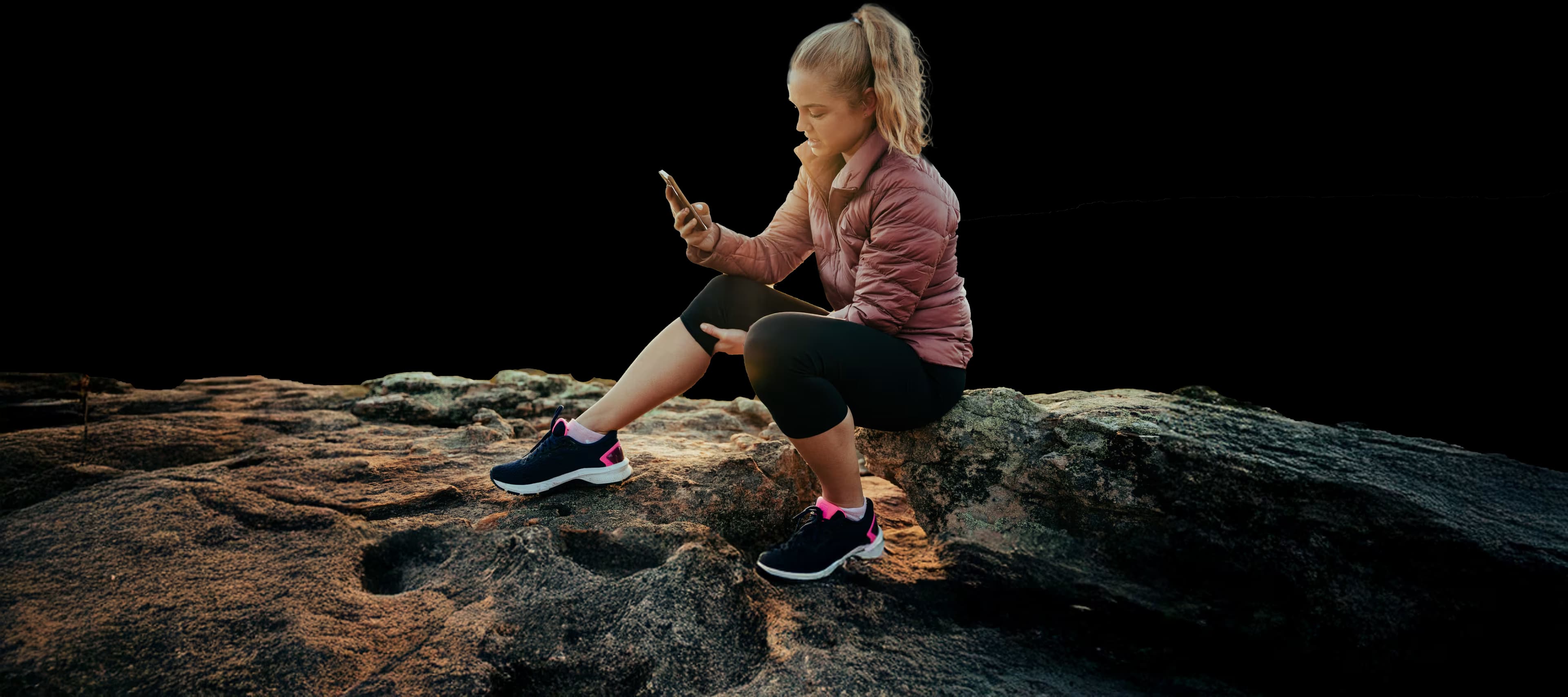 Girl sitting on rock